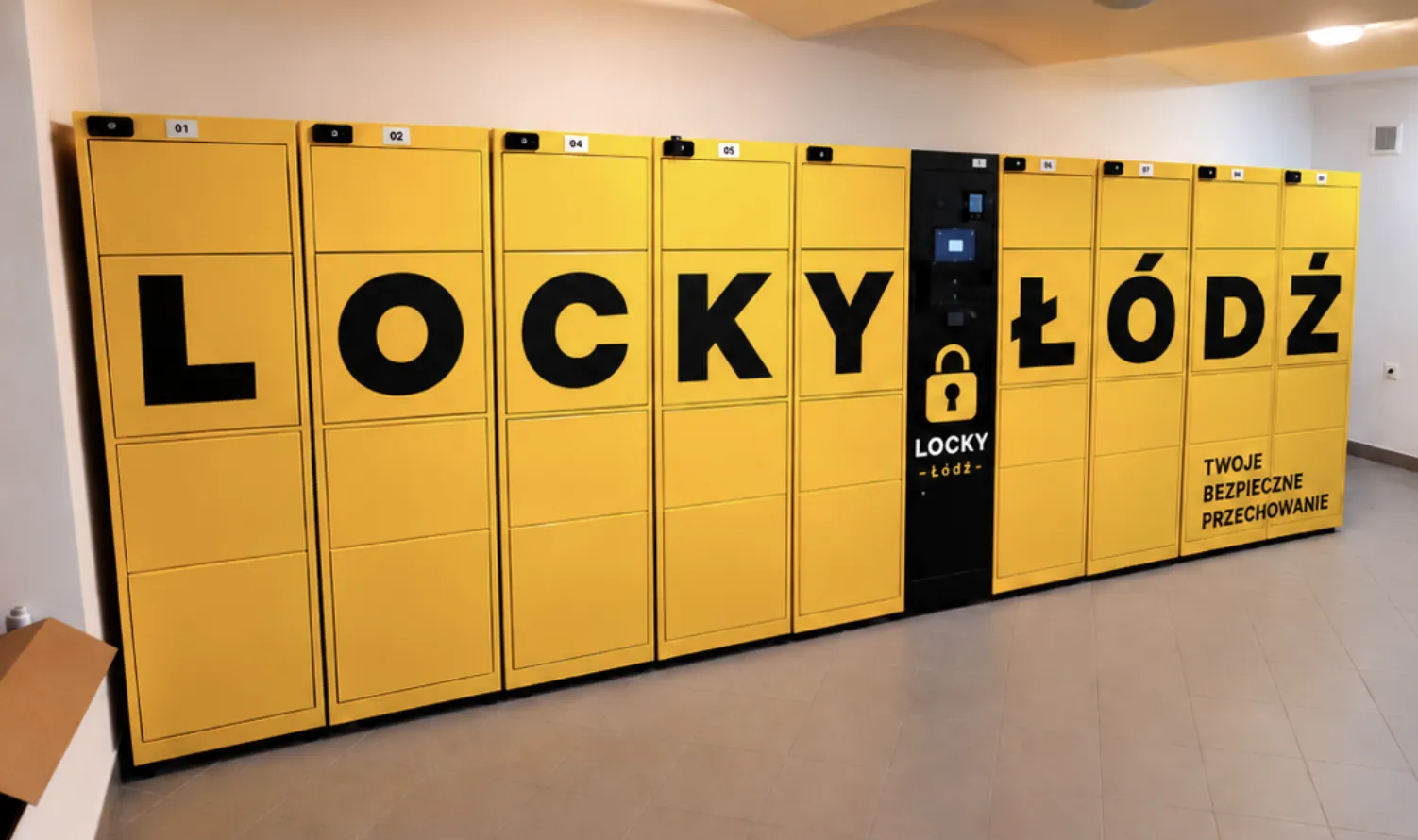 Luggage storage Łódź: a wall of yellow Locky lockers spelling LOCKY ŁÓDŹ in giant letters across the doors